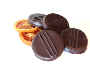 
                  
                    Load image into Gallery viewer, Our house made glazed fruits and peels. These are not like dried fruit. They are juicy, sweet and delicious! Orange and Apricot Slices are hand dipped into 62% Dominican Republic Dark Chocolate and the Orange Peels are completely enrobed, then sent through our enrober a second time for a thick chocolate coating!
                  
                