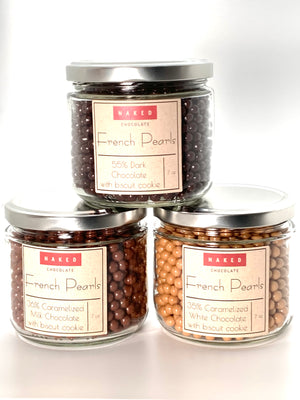 
                  
                    Load image into Gallery viewer, French Pearls are a little biscuit cookie enrobed in in our direct trade chocolate. We highly recommend pouring these over ice cream, decorating desserts, or just for snacking.  Toasted 38%  White Chocolate pearls have notes of toast, fresh dairy and butterscotch.  Caramelized 36% Milk chocolate, notes of caramel and cream.  55% Dark Chocolate , notes of cocoa and fudge brownie
                  
                