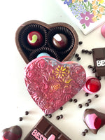 Just another way to say I Love You! Our edible chocolate heart eat the box withflowers detail. Hand painted with all natural cocoa butter and filled with 3 bon bons.  It tastes even better than it looks.