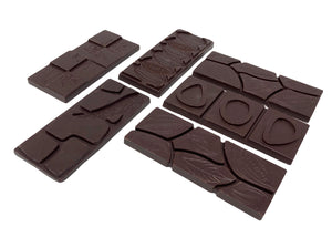 
                  
                    Load image into Gallery viewer, We are among a small handful of chocolatiers sourcing single origin chocolate from around the world that you likely won&amp;#39;t see anywhere else. Rare varietals of fair and direct trade cacao from small family farms. Grab a few and taste the amazing notes that different soils and climates produce! All dark bars are vegan as there are no animal products in the ingredients. We do use shared equipment so there may be trace amounts of dairy.
                  
                